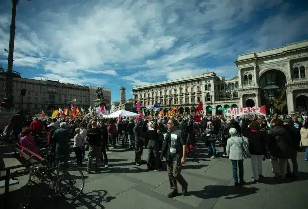 a large group of people standing in a plaza